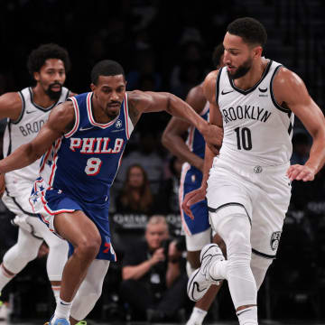 Oct 16, 2023; Brooklyn, New York, USA; Philadelphia 76ers guard De'Anthony Melton (8) dribbles up court against Brooklyn Nets guard Ben Simmons (10) during the first quarter at Barclays Center. Mandatory Credit: Vincent Carchietta-USA TODAY Sports