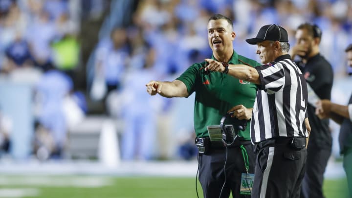 Oct 14, 2023; Chapel Hill, North Carolina, USA; Miami Hurricanes head coach Mario Cristobal argues with an official in the first half against the North Carolina Tar Heels at Kenan Memorial Stadium. Mandatory Credit: Nell Redmond-USA TODAY Sports