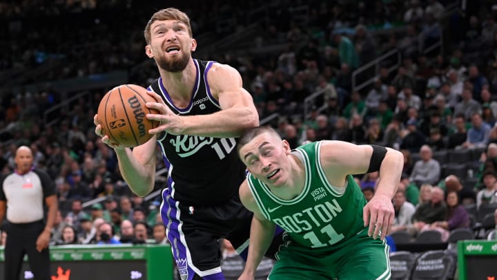 Apr 5, 2024; Boston, Massachusetts, USA; Sacramento Kings forward Domantas Sabonis (10) elbows Boston Celtics guard Payton Pritchard (11) while shooting during the second half at TD Garden. Mandatory Credit: Eric Canha-USA TODAY Sports