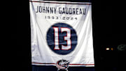 Oct 15, 2024; Columbus, Ohio, USA; A banner is raised in remberance of Johnny Gaudreau before the game between the Columbus Blue Jackets and Florida Panthers at Nationwide Arena. Mandatory Credit: Russell LaBounty-Imagn Images