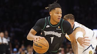 Oct 27, 2025; Minneapolis, Minnesota, USA; Minnesota Timberwolves guard Terrence Shannon Jr. (1) works around Denver Nuggets center Jonas Valanciunas (17) in the third quarter at Target Center.