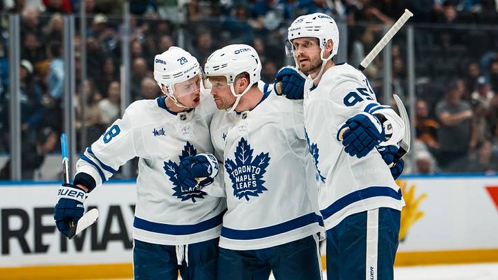 Jan 31, 2026; Vancouver, British Columbia, CAN; Toronto Maple Leafs defenseman Troy Stecher (28) and forward Max Domi (11) and defenseman Oliver Ekman-Larsson (95) celebrate Domi’s goal against the Vancouver Canucks in the third period at Rogers Arena. Mandatory Credit: Bob Frid-Imagn Images
