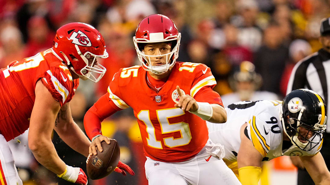 Dec 26, 2021; Kansas City, Missouri, USA; Kansas City Chiefs quarterback Patrick Mahomes (15) signals to a receiver as Pittsburgh Steelers outside linebacker T.J. Watt (90) defends during the first half at GEHA Field at Arrowhead Stadium. Mandatory Credit: Jay Biggerstaff-Imagn Images