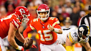 Dec 26, 2021; Kansas City, Missouri, USA; Kansas City Chiefs quarterback Patrick Mahomes (15) signals to a receiver as Pittsburgh Steelers outside linebacker T.J. Watt (90) defends during the first half at GEHA Field at Arrowhead Stadium. Mandatory Credit: Jay Biggerstaff-Imagn Images