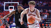 Feb 15, 2025; Champaign, Illinois, USA;  Illinois Fighting Illini guard Kasparas Jakucionis (32) runs past Michigan State Spartans guard Tre Holloman (5) during the first half at State Farm Center. Mandatory Credit: Ron Johnson-Imagn Images
