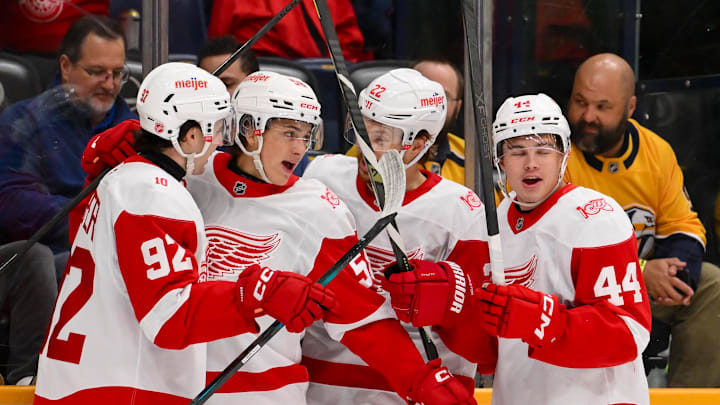 Mar 2, 2026; Nashville, Tennessee, USA;  Detroit Red Wings center Emmitt Finnie (58) celebrates with his teammates after scoring a goal against the Nashville Predators during the first period at Bridgestone Arena. Mandatory Credit: Steve Roberts-Imagn Images