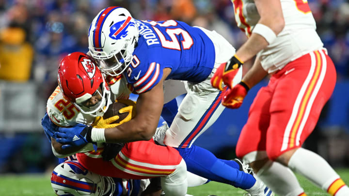 Jan 21, 2024; Orchard Park, NY; Buffalo Bills defensive end Greg Rousseau (50) tackles Kansas City Chiefs running back Clyde Edwards-Helaire (25) in the first half of the 2024 AFC divisional round game at Highmark Stadium. 