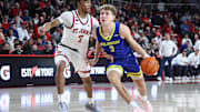 Dec 28, 2024; Queens, New York, USA; Delaware Fightin Blue Hens guard Cavan Reilly (3) looks to drive past St. John's Red Storm guard Simeon Wilcher (7) in the first half at Carnesecca Arena. Mandatory Credit: Wendell Cruz-Imagn Images