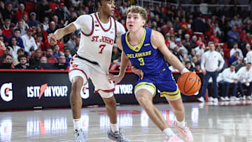 Dec 28, 2024; Queens, New York, USA; Delaware Fightin Blue Hens guard Cavan Reilly (3) looks to drive past St. John's Red Storm guard Simeon Wilcher (7) in the first half at Carnesecca Arena. Mandatory Credit: Wendell Cruz-Imagn Images