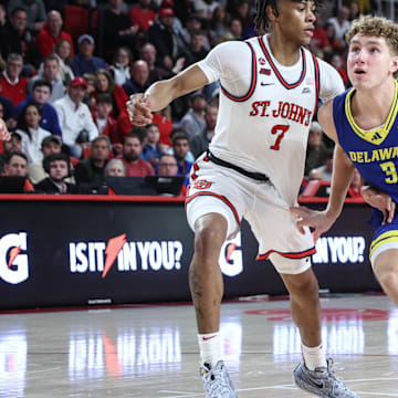 Dec 28, 2024; Queens, New York, USA; Delaware Fightin Blue Hens guard Cavan Reilly (3) looks to drive past St. John's Red Storm guard Simeon Wilcher (7) in the first half at Carnesecca Arena. Mandatory Credit: Wendell Cruz-Imagn Images
