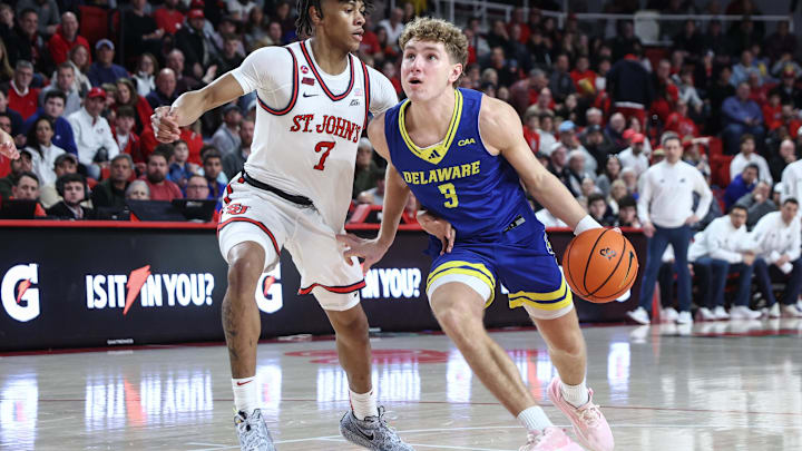 Dec 28, 2024; Queens, New York, USA; Delaware Fightin Blue Hens guard Cavan Reilly (3) looks to drive past St. John's Red Storm guard Simeon Wilcher (7) in the first half at Carnesecca Arena. Mandatory Credit: Wendell Cruz-Imagn Images