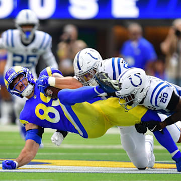 Sep 28, 2025; Inglewood, California, USA; Los Angeles Rams tight end Tyler Higbee (89) is brought down by Indianapolis Colts cornerback Mekhi Blackmon (29) and linebacker Chad Muma (55) during the first half at SoFi Stadium. Mandatory Credit: Gary A. Vasquez-Imagn Images
