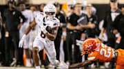 Oct 18, 2025; Stillwater, Oklahoma, USA; Cincinnati Bearcats running back Evan Pryor (6) runs the ball around Oklahoma State Cowboys safety Kenneth Harris (23) during the first half at Boone Pickens Stadium. Mandatory Credit: William Purnell-Imagn Images