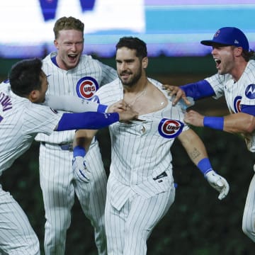 Aug 1, 2024; Chicago, Illinois, USA; Chicago Cubs outfielder Mike Tauchman (40) celebrates with teammates his walk-off single against the St. Louis Cardinals during the ninth inning at Wrigley Field. 