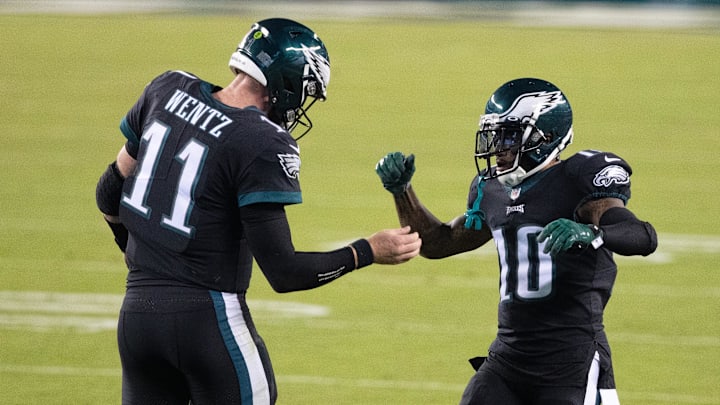 Oct 22, 2020; Philadelphia, Pennsylvania, USA; Philadelphia Eagles quarterback Carson Wentz (11) celebrates with wide receiver DeSean Jackson (10) after scoring a touchdown against the New York Giants during the first quarter at Lincoln Financial Field. Mandatory Credit: Bill Streicher-Imagn Images