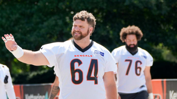 Cincinnati Bengals center Ted Karras (64) waves to a fan as he’s walking towards the field at Bengals practice, Tuesday, June 4, 2024, in Cincinnati.