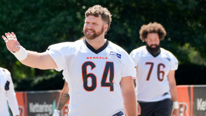 Cincinnati Bengals center Ted Karras (64) waves to a fan as he’s walking towards the field at Bengals practice, Tuesday, June 4, 2024, in Cincinnati.