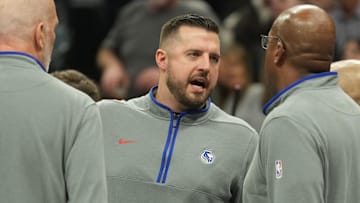 Dec 4, 2023; Sacramento, California, USA; Sacramento Kings assistant coach Luke Loucks (center) talks to head coach Mike Brown (right) during the second quarter against the New Orleans Pelicans at Golden 1 Center. Mandatory Credit: Darren Yamashita-Imagn Images