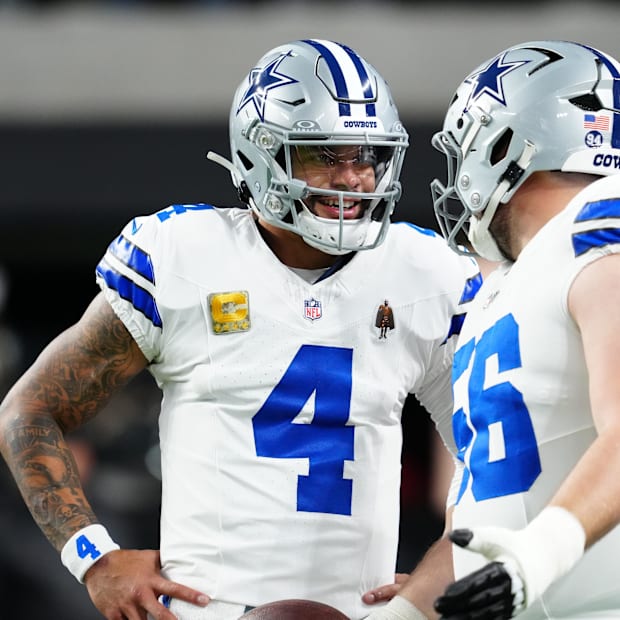 Dallas Cowboys quarterback Dak Prescott and center Cooper Beebe warm up before a game against the Las Vegas Raiders
