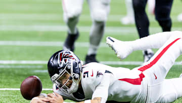 Jan 7, 2024; New Orleans, Louisiana, USA; Atlanta Falcons quarterback Desmond Ridder (9) looks the football for a fumble as New Orleans Saints defensive end Payton Turner (98) recovers it during the second half at Caesars Superdome. Mandatory Credit: Stephen Lew-Imagn Images