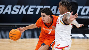 Mar 14, 2025; Indianapolis, IN, USA; Illinois Fighting Illini forward Will Riley (7) dribbles the ball while Maryland Terrapins guard DeShawn Harris-Smith (5) defends in the first half  at Gainbridge Fieldhouse. Mandatory Credit: Trevor Ruszkowski-Imagn Images