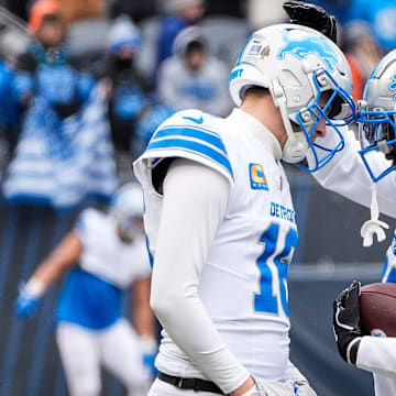 Detroit Lions quarterback Jared Goff embraces safety Kerby Joseph before a game against Chicago Bears.