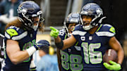 Jan 8, 2023; Seattle, Washington, USA; Seattle Seahawks wide receiver Tyler Lockett (16) celebrates with tight end Colby Parkinson (84) and wide receiver Cade Johnson (88) after catching a touchdown pass against the Los Angeles Rams during the third quarter at Lumen Field.