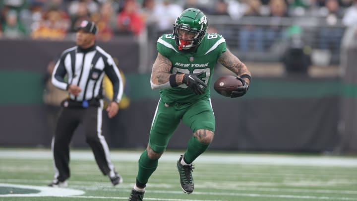 Dec 24, 2023; East Rutherford, New Jersey, USA; New York Jets tight end Tyler Conklin (83) gains yards after a catch during the first half against the Washington Commanders at MetLife Stadium.  