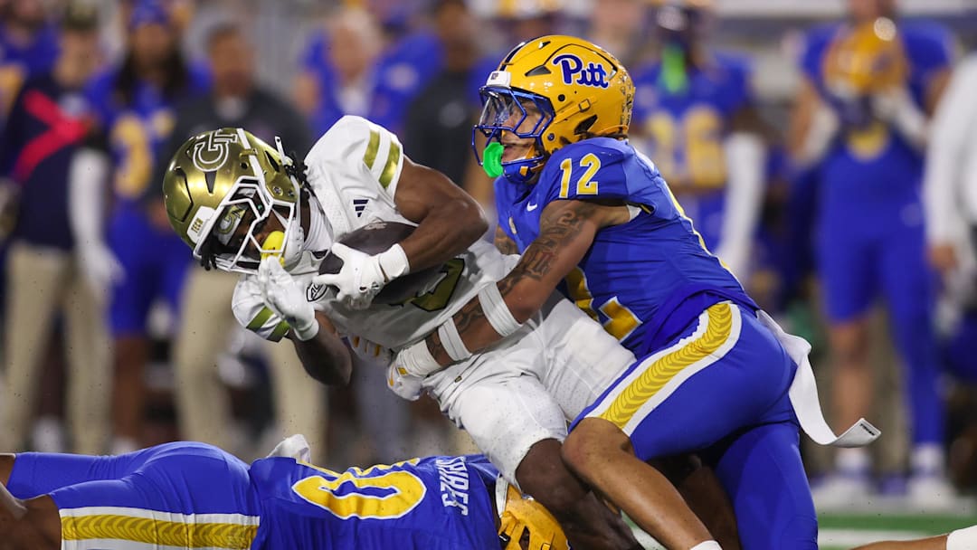 Nov 22, 2025; Atlanta, Georgia, USA; Georgia Tech Yellow Jackets wide receiver Malik Rutherford (8) is tackled by Pittsburgh Panthers defensive back Cruce Brookins (12) in the second quarter at Bobby Dodd Stadium at Hyundai Field. Mandatory Credit: Brett Davis-Imagn Images
