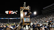 Nov 26, 2016; University Park, PA, USA; Penn State Nittany Lions football players carry the Land-Grant trophy following the competition of the game at Beaver Stadium. Penn State defeated Michigan State 45-12. Mandatory Credit: Matthew O'Haren-Imagn Images