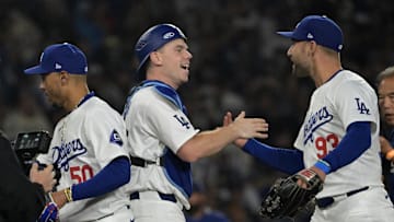Los Angeles Dodgers catcher Will Smith (16) and center fielder Kevin Kiermaier (93) after clinching the National League West by defeating the San Diego Padres 7-2 at Dodger Stadium on Sept. 26, 2024.