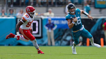 Sep 17, 2023; Jacksonville, Florida, USA;  Jacksonville Jaguars quarterback Trevor Lawrence (16) runs with the ball chased by Kansas City Chiefs defensive end Felix Anudike-Uzomah (97) in the second quarter at EverBank Stadium. Mandatory Credit: Nathan Ray Seebeck-USA TODAY Sports