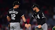 Chicago White Sox shortstop Colson Montgomery (12) and right fielder Mike Tauchman (18) celebrate a victory against the Los Angeles Angels at Angel Stadium. 