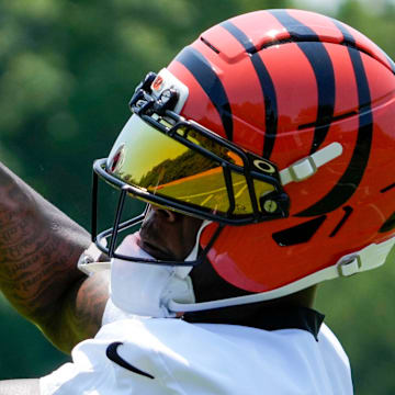 Cincinnati Bengals wide receiver Tee Higgins (5) catches a pass during a session of organized team activities on the Bengals practice field at Paycor Stadium in downtown Cincinnati on Tuesday, June 3, 2025.