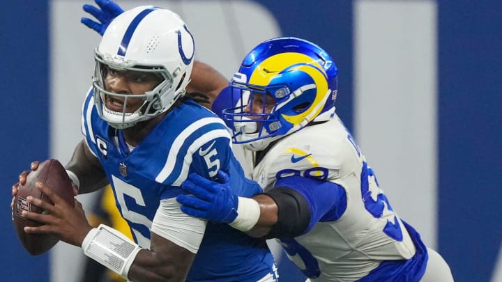 Indianapolis Colts quarterback Anthony Richardson (5) evades this tackler on a third quarter scramble during game action against the Los Angeles Rams at Indianapolis Colts, on Sunday, Oct. 1, 2023, at Lucas Oil Stadium in Indianapolis.