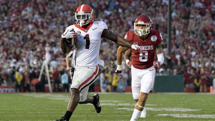 Georgia Bulldogs running back Sony Michel (1) is pursued by Oklahoma Sooners safety Kahlil Haughton (8)