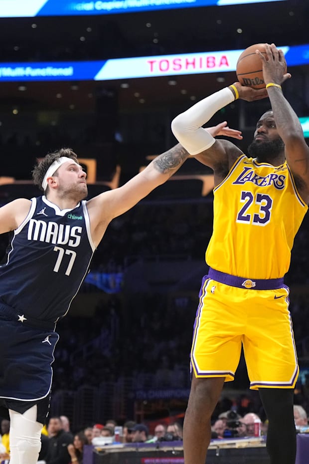 Los Angeles Lakers forward LeBron James shoots the ball against Dallas Mavericks guard Luka Doncic. 