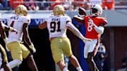 Oct 5, 2024; Charlottesville, Virginia, USA; Virginia Cavaliers wide receiver Malachi Fields (8) throws a pass against Boston College Eagles defensive lineman George Rooks (91) during the third quarter at Scott Stadium. Mandatory Credit: Peter Casey-Imagn Images
