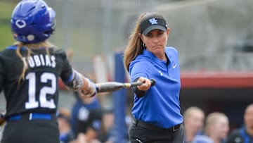 May 11, 2023; Fayetteville, AK, USA;  Kentucky Wildcats head coach Rachel Lawson takes a the bat from infielder Margaret Tobias (12) during the rain delayed first round game against the Florida Gators in the SEC Softball Tournament. Mandatory Credit: Brett Rojo-Imagn ImagesMandatory Credit: Brett Rojo-Imagn Images