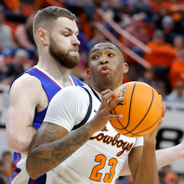 Oklahoma State Cowboys center Brandon Garrison (23) tries to get past Kansas Jayhawks center Hunter Dickinson (1) during a college basketball game between the Oklahoma State University Cowboys (OSU) and the Kansas Jayhawks at Gallagher-Iba Arena in Stillwater, Okla., Tuesday, Jan. 16, 2024.