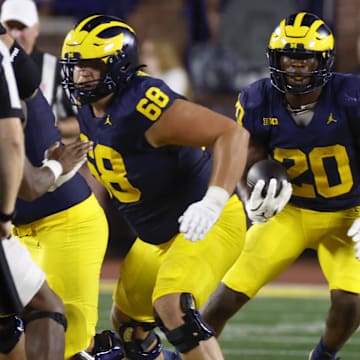 Aug 31, 2024; Ann Arbor, Michigan, USA;  Michigan Wolverines running back Kalel Mullings (20) rushes against the Fresno State Bulldogs in the first half at Michigan Stadium. Mandatory Credit: Rick Osentoski-Imagn Images