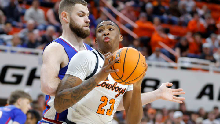 Oklahoma State Cowboys center Brandon Garrison (23) tries to get past Kansas Jayhawks center Hunter Dickinson (1) during a college basketball game between the Oklahoma State University Cowboys (OSU) and the Kansas Jayhawks at Gallagher-Iba Arena in Stillwater, Okla., Tuesday, Jan. 16, 2024.