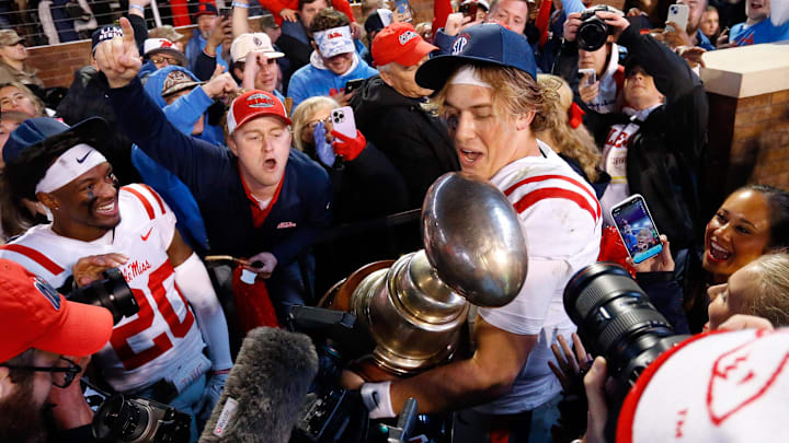 Ole Miss quarterback Jaxson Dart (2) shares the Egg Bowl trophy with fans after defeating the Mississippi State Bulldogs at Davis Wade Stadium. If Mississippi State fans hope to celebrate an Egg Bowl, they'll need to stay ahead of the Rebels in recruting.