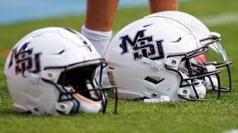 Mississippi State Bulldogs helmets sit on the sidelines before a game against the Florida Gators at Ben Hill Griffin Stadium.