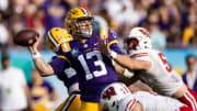 Jan 1, 2024; Tampa, FL, USA; LSU Tigers quarterback Garrett Nussmeier (13) throws the ball under pressure during the second half against the Wisconsin Badgers at the Reliaquest Bowl at Raymond James Stadium. Mandatory Credit: Matt Pendleton-USA TODAY Sports