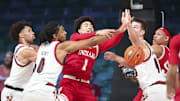 Indiana Hoosiers guard Myles Rice (1) battles for the ball with Louisville Cardinals forward Noah Waterman (93) and Louisville Cardinals forward James Scott (0) during the first half at the Atlantis Resort.