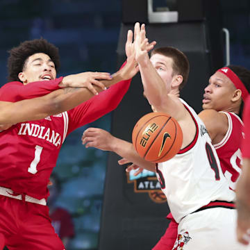 Indiana Hoosiers guard Myles Rice (1) battles for the ball with Louisville Cardinals forward Noah Waterman (93) and Louisville Cardinals forward James Scott (0) during the first half at the Atlantis Resort.