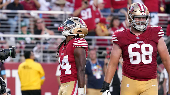 Sep 9, 2024; Santa Clara, California, USA; San Francisco 49ers running back Jordan Mason (left) reacts after scoring a touchdown against the New York Jets during the third quarter at Levi's Stadium. Mandatory Credit: Darren Yamashita-Imagn Images