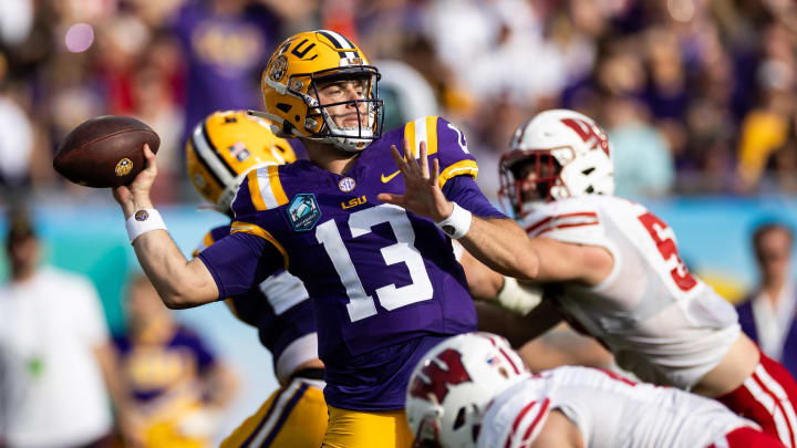 Jan 1, 2024; Tampa, FL, USA; LSU Tigers quarterback Garrett Nussmeier (13) throws the ball under pressure during the second half against the Wisconsin Badgers at the Reliaquest Bowl at Raymond James Stadium. Mandatory Credit: Matt Pendleton-USA TODAY Sports