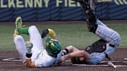 Oregon’s Anson Aroz, right, collides with Utah Valley catcher Mason Strong at the plate in the eighth inning of the Eugene NCAA Regional at PK Park.